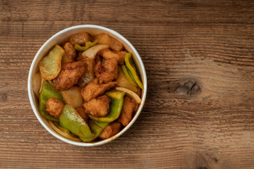 sweet and sour chicken on a wooden table