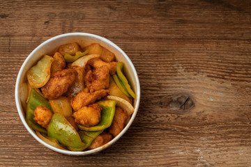 sweet and sour chicken on a wooden table