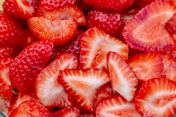 A full frame photograph of sliced strawberries