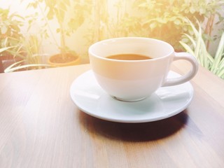 cup of coffee on wooden table