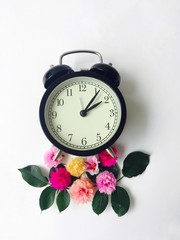 vintage alarm clock and flowers