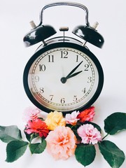 vintage alarm clock and flowers