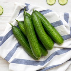 Fresh raw green cucumbers, top view. Flat lay, from above, overhead.