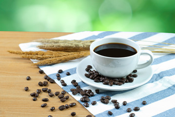 cup of coffee and beans on wooden table