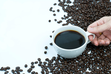 cup of coffee with beans on white background