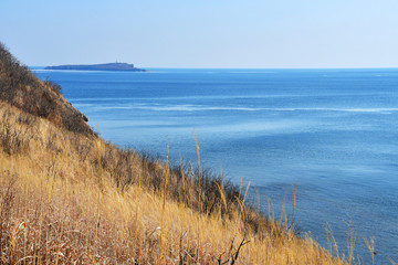 Russia, Vladivostok, Russkiy island. Coast of bay New Dzhigit and Cape of Tabizin in the background in winter