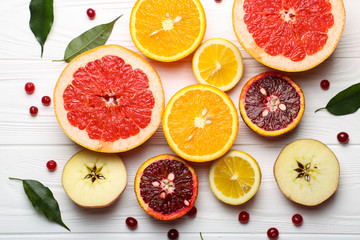 Sliced citrus fruits, vitamins, oranges, grapefruits, lemons, apples,  juicy fruits background