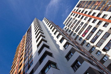Fototapeta na wymiar bottom view of a tall apartment building