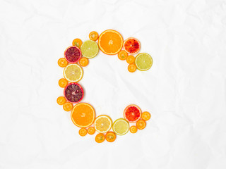 the letter C shaped with different slices of healthy fruits