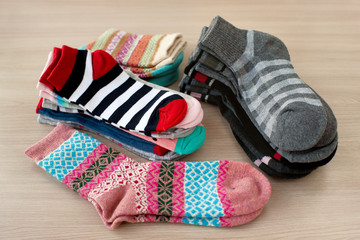A lot of colorful socks. Clothing in the form of socks. Stacks of socks of different sizes and colors.