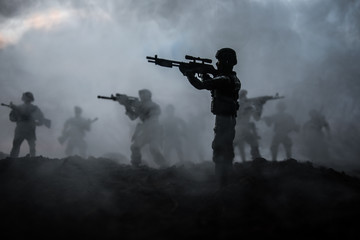 Naklejka premium War Concept. Military silhouettes fighting scene on war fog sky background, World War Soldiers Silhouettes Below Cloudy Skyline At night. Attack scene. Armored vehicles. Tanks battle. Decoration