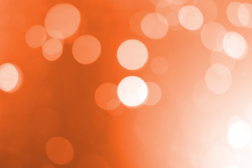 White bokeh on an orange background