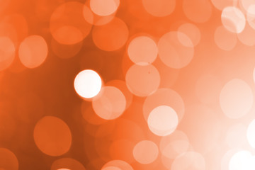White bokeh on an orange background