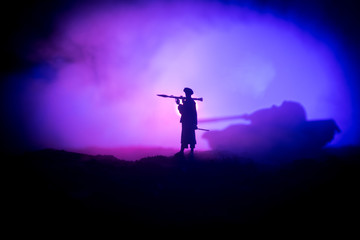 Fototapeta na wymiar Military soldier silhouette with bazooka. War Concept. Military silhouettes fighting scene on war fog sky background, Soldier Silhouette aiming to the target at night