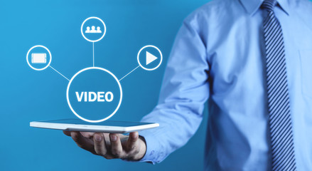 Man holding tablet with Video sign. Video marketin