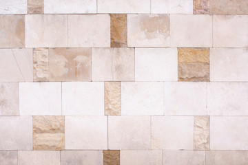 Wall Cladding Of Square And Rectangular Light Beige Smooth And Rough Stone Slabs, Mosaic Laying.