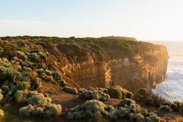 Fototapeta na wymiar Rock cliff with sunset light facing towards the ocean.