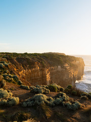 Rock cliff with sunset light facing towards the ocean.