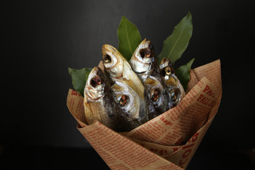 dried fish wrapped in a newspaper as a bouquet