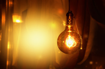 Glowing light bulbs on the yellow-brown background. Image