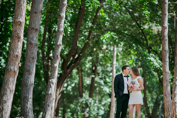 Happy couple walks in the park enjoying tender moments.