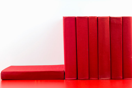 Red books on a red and white background.