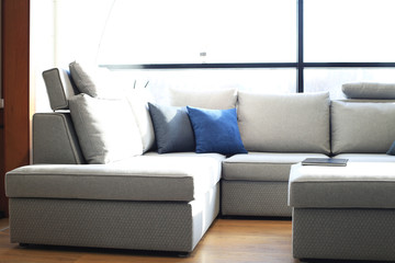 Comfortable large light gray sofa in a bright room