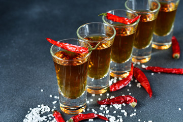 five glasses of alcohol and salt  and red chili, a party at the bar, a menu for the bar. Selective focus and copy space, Tequila shots, vodka,whisky, rum