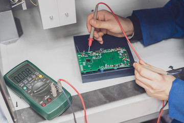 worker use electric multimeter and check voltage b