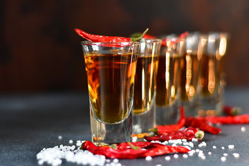 five glasses of alcohol and salt  and red chili, a party at the bar, a menu for the bar. Selective focus and copy space, Tequila shots, vodka,whisky, rum