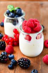 diet breakfast or lunch : organic yogurt with fresh berries of blackberries, raspberries, blueberries, red currants. the concept of a healthy lifestyle, diet food. selective focus and copy space