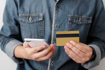 Man hand holding credit card and smart phone for  shopping online concept, business, finance and technology, online payment, digital money concept