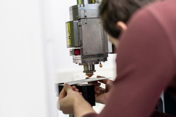 portrait of person adjust industrial milling machine b