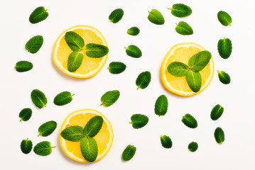 Mint leaves am lemon slices on white background