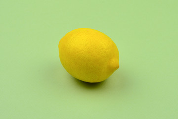 Lemon isolated on green background. Space for test or design.