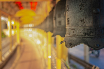 Chinese temple bell miniature with blessing text mean happy on blurred background