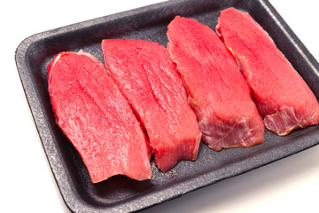 Raw veal in container isolated on white background.