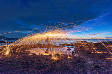 Amazing Fire dancing steel wool and lamp in the night.