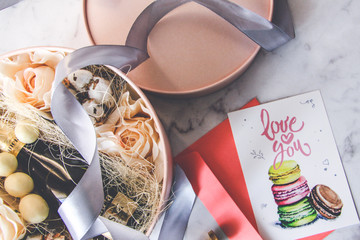 Top view of roses in Gift box with gray ribbon and chocolate, champagne, cotton, Valentine's day...