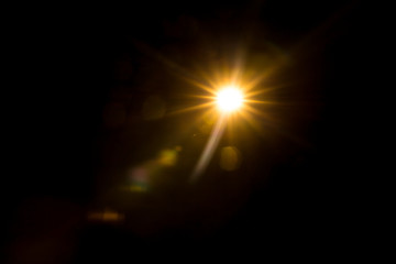 Abstract Natural Sun flare on the black background.