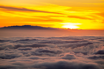 Fototapeta na wymiar Sunset over the clouds