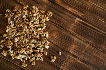 Peeled walnuts on a natural wooden surface from pine boards