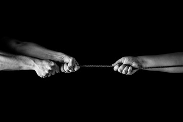 Tug war, man vs woman pulling rope in opposite directions unequally, uneven. copy space - obrazy, fototapety, plakaty