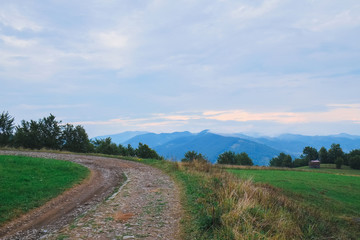 Fototapeta na wymiar The mountain road in sunset light, Carpathians, Eastern Europe