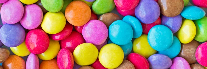 Foto op Canvas Colorful round candies panoramic background © Delphotostock