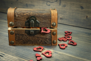 Heart shapes spilling from trunk or treasure chest