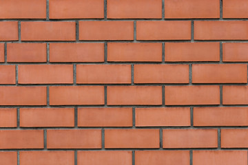 Wall of red bricks close-up. Texture for background and design.