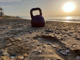 A Kettlebell in the Sand Near the Sea