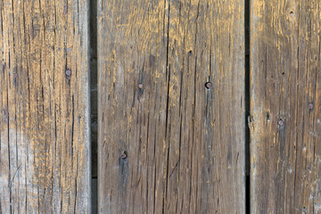 Old weathered  wooden boards painted yellow paint. For background and design.