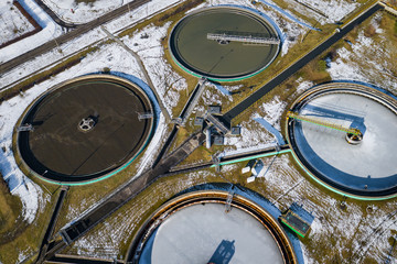 Sewage farm. Static aerial photo looking down onto the clarifying tanks. Industrial place. Geometric background texture. Photo captured with drone.